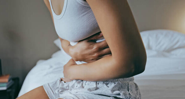 Lady holding her sore stomach.